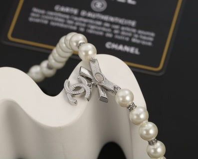 Chanel Romantic Pearl Bow Charm Necklace