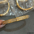 Cartier wide-band bracelet with a center stone and pavé diamonds